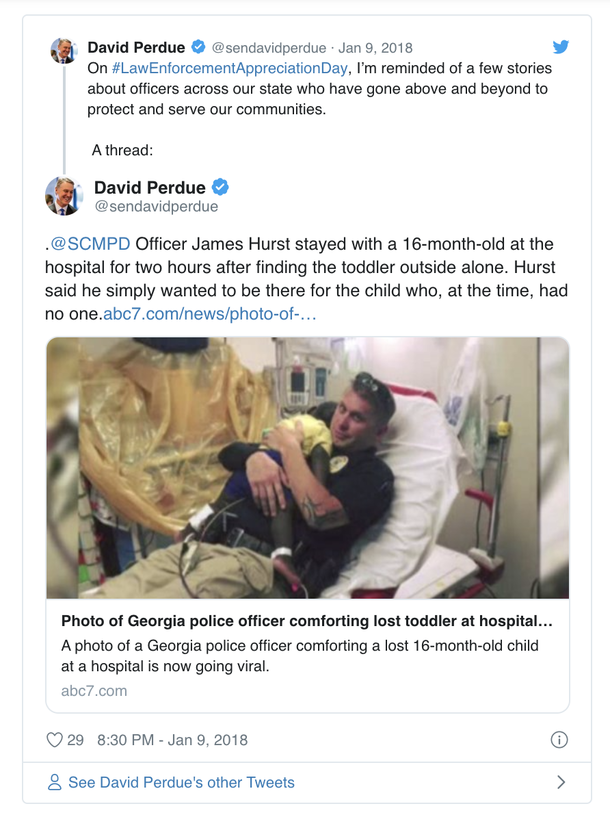 Photo of cop holding abandoned child in hospital bed goes viral immediately